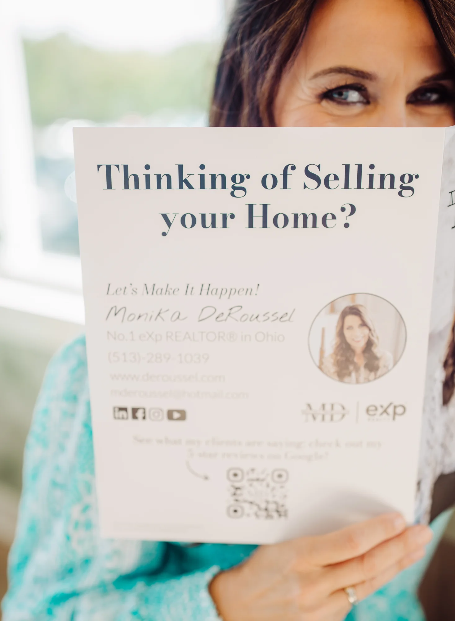 Monika holding up her Thinking of Selling Your Home flyer